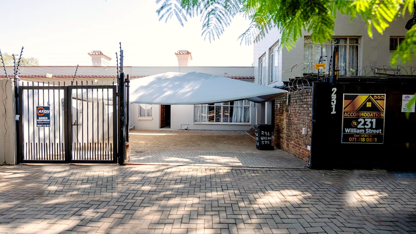 The gated entrance and house at 231 William Street, Brooklyn
